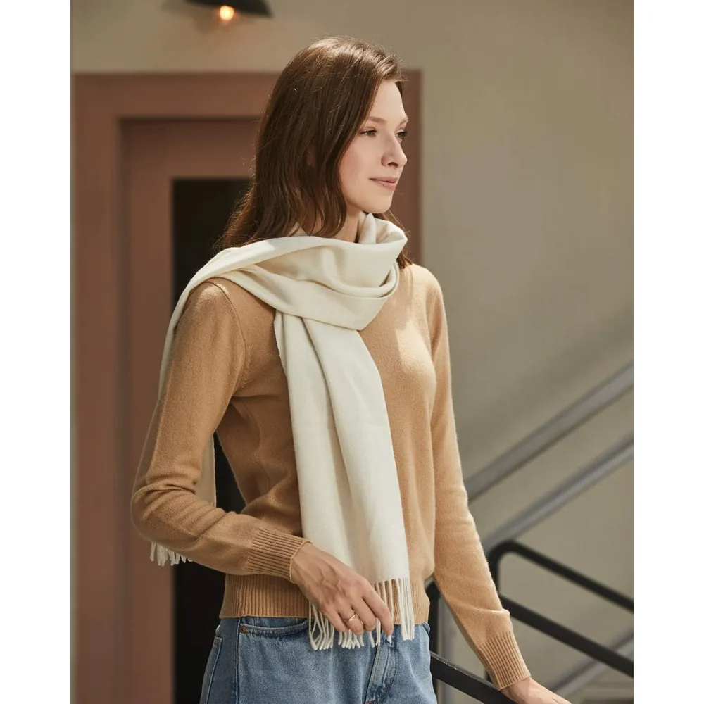 Ivory cashmere scarf worn loosely around the neck