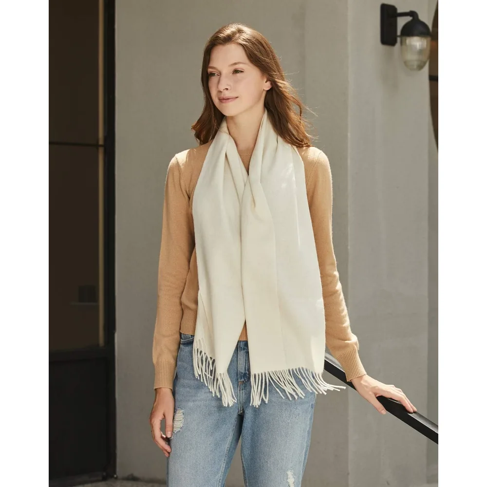 Ivory cashmere scarf worn with a sweater